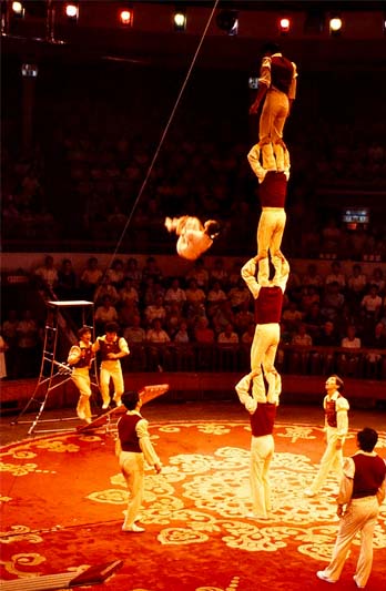 An acrobat is in midair after being launched from a springboard in this performance in China in 1987.