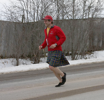 Man running marathon in a kilt