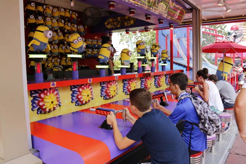 Four kids at a shooting arcade aiming for Sponge Bob Squarepants.