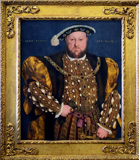 An oil and tempera on panel portrait of King Henry VIII in a gold frame.