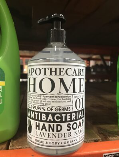 A hand pump of antibacterial soap in an old-fashioned style bottle