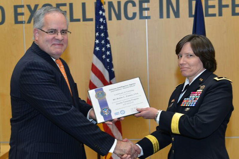 Man in a suit presenting a certificate to woman general