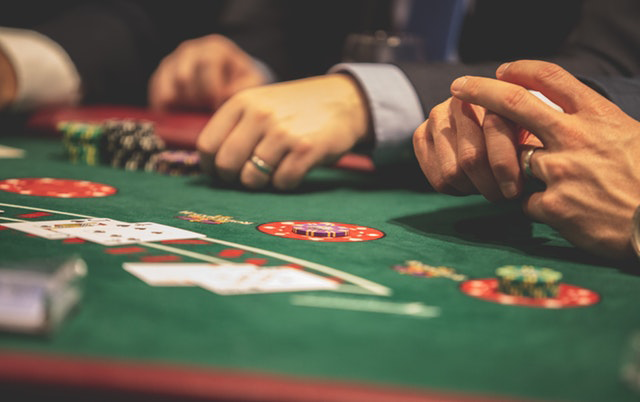 A close-up of hands at a poker table