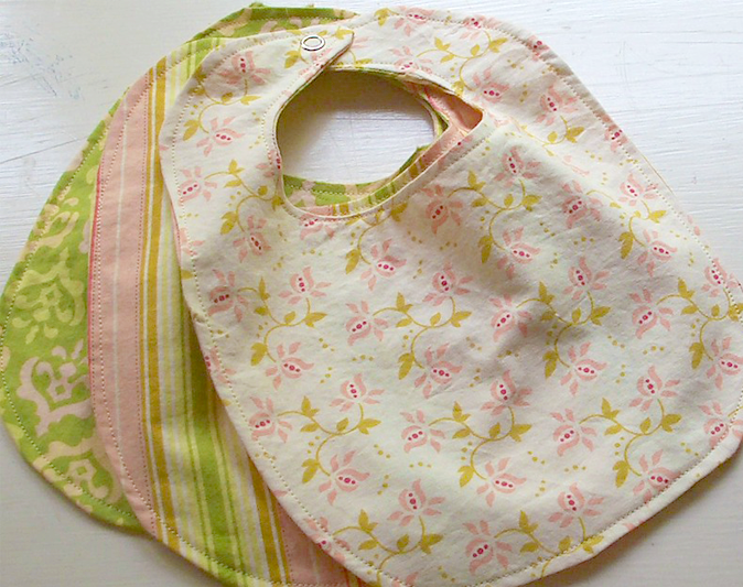 Three homemade bibs in mints and pinks