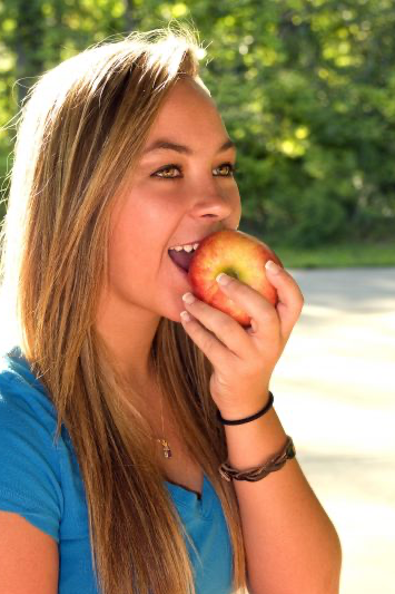 Young woman biting an apple