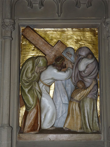 A framed bas relief of Jesus carrying his cross