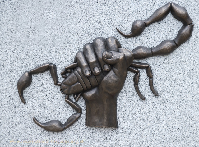 Scorpion and Clenched Fist motif as seen on a brigader cap badge was used by sculptor Charlie Carter for the memorial.