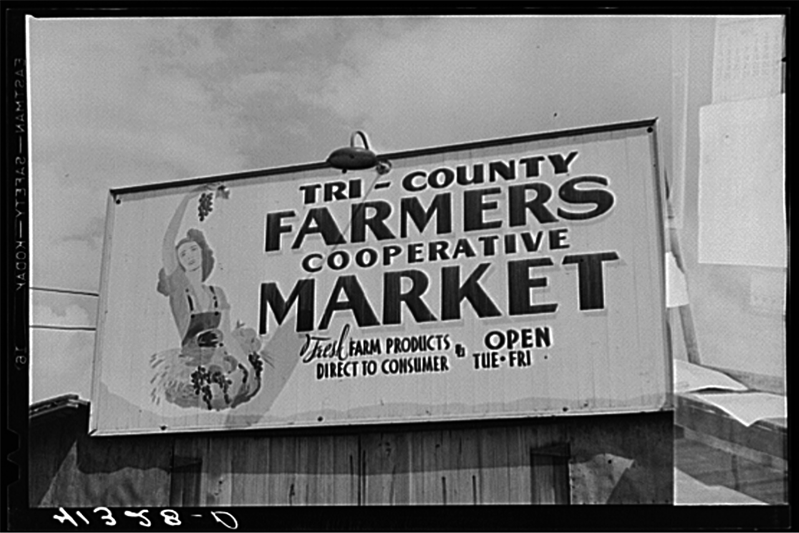 A black-and-white photo of a farmers cooperative sign.