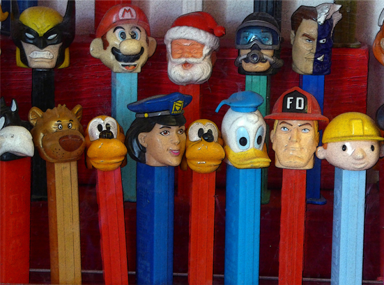 Two rows of 13 Pez dispensers