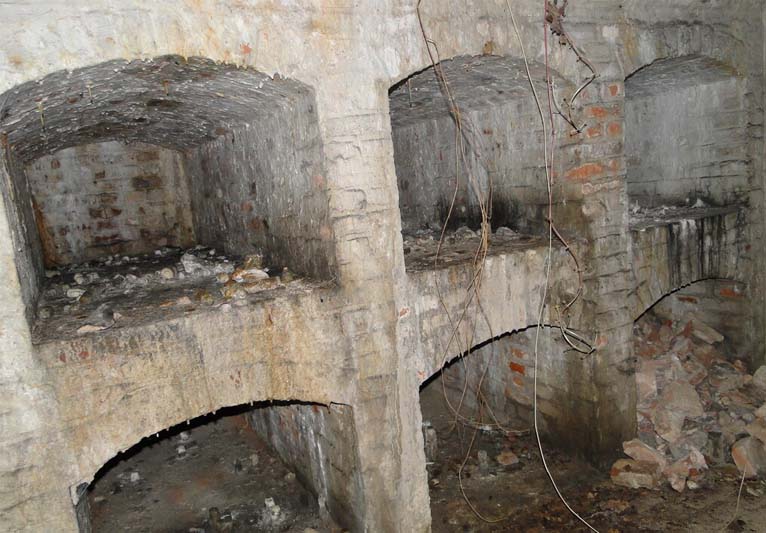 A close-up of four empty vaulted cavities in a crypt.