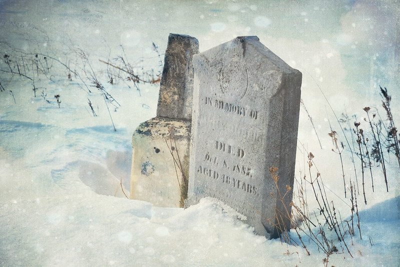 Two tombstones in the snow.