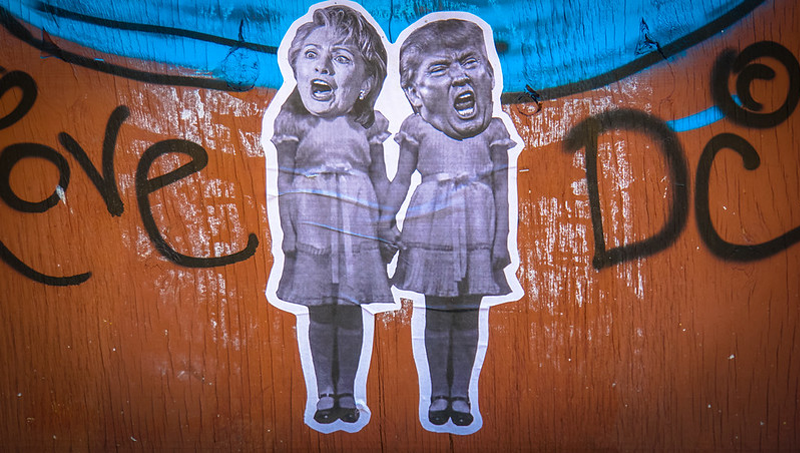 A cartoon substituing Hilary Clinton's and Donald Trump's heads on girls' bodies against a deep orange background