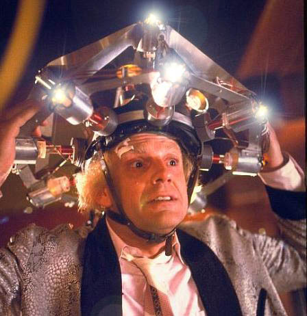 Doc Brown putting a huge clear helmet over his head