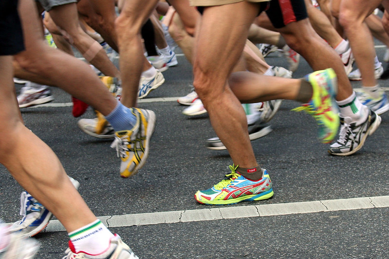 Legs of runners racing by