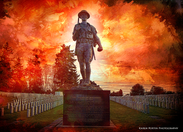 A statue of a WWI soldier striding forward in a cemetery with fire filling the background