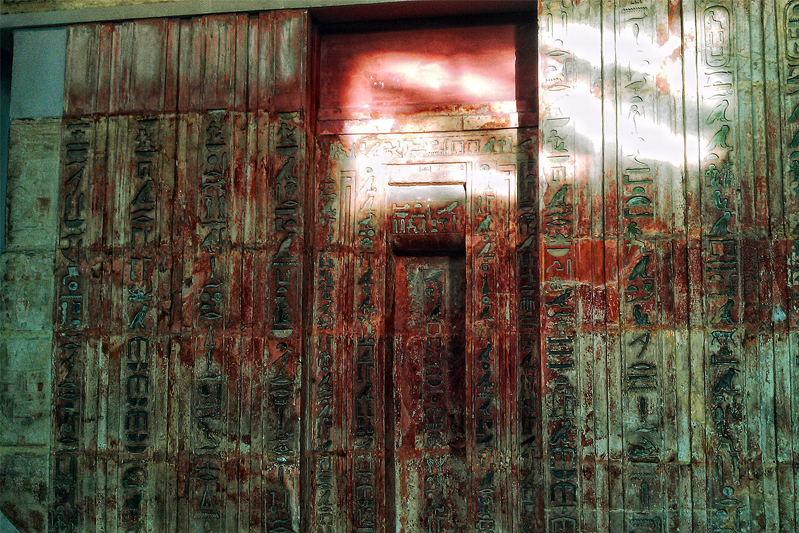 The false door consists of the false door proper with two lines of text on each side containing the titles of Ptahshepses, flanked on both sides by panelled walls carrying the biographical inscription of Ptahshepses