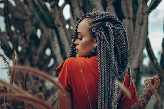 Black woman in profile with a head full of long, simple, full braids