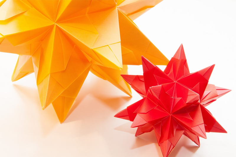 A large and small 3-d origami stars in yellow and red