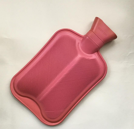 An old-fashioned pink hot water bottle.