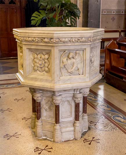 A carved marble baptismal font created in 1894 by the sculptor James Pearse, Dublin.