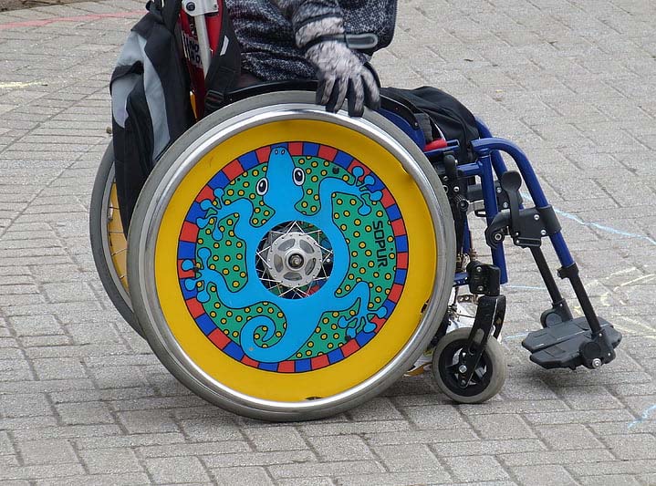 Close-up of a  person's highly decorated wheelchair.