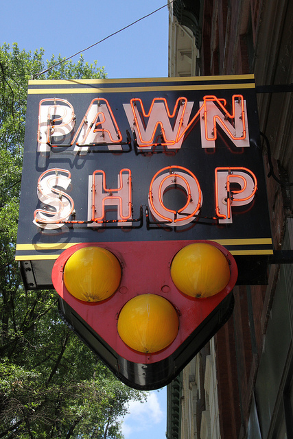 Close-up of a sign saying Pawn Shop with three balls in a triangle formation below it