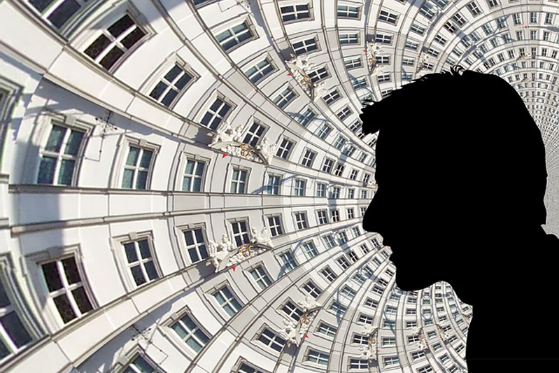 Curved tube of windows with the silhouette of a man's head in profile