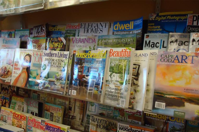 Rows of assorted home decor magazines on shelves.