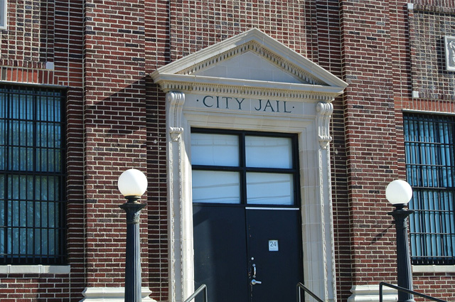 Close-up of the front door of the red brick city jail.