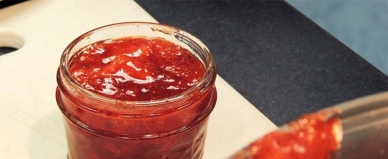 Close-up of a jar of strawberry jam.