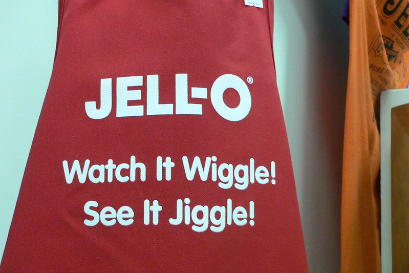Jello motto printed on a burgundy apron.