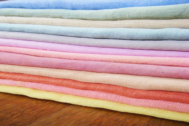 Stack of folded linen in soft cheerul colors