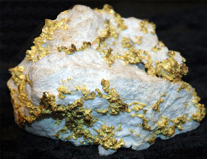 A chunk of white quartz with nodules of gold