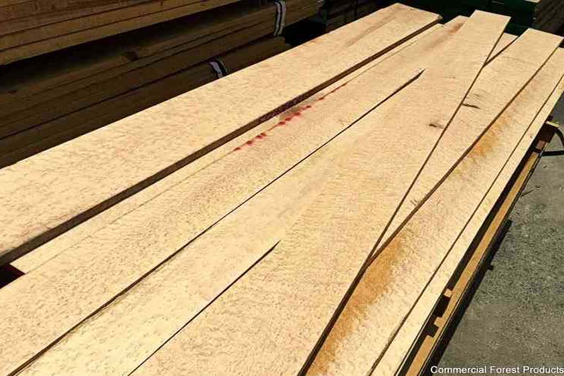 An opened bundle of hardwood lumber that has birdseye figure.