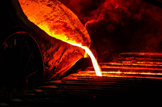 Melted iron being poured from a bucket