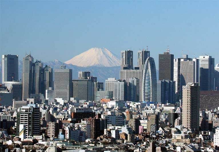 The crowded skyline of the metropolis of Tokyo with Mount Fuji in the background.
