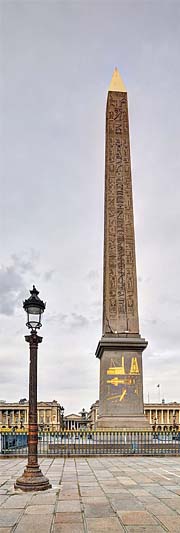 Ared granite monolithic column, 23 metres (75 feet) high, including the base, which weighs over 250 metric tons (280 short tons).
