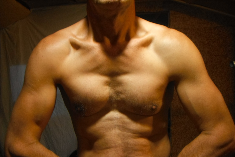 A man's naked chest with the muscles pumped up