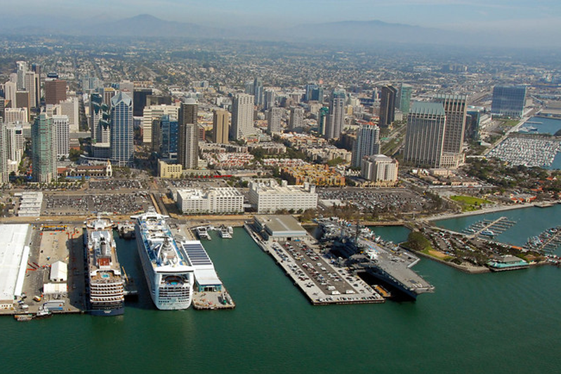 Aerial view angled from the ocean towards San Diego with cruise ships neatly lined up