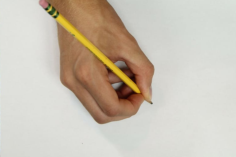 Hand holding a no 2 pencil