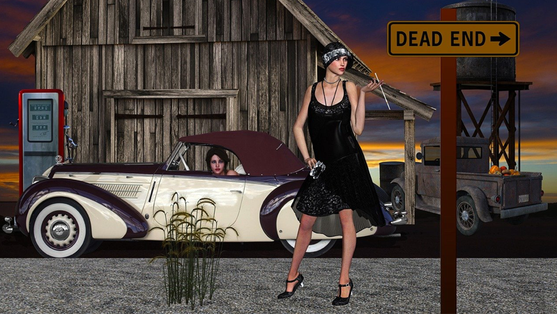 A slick oldstyle convertible with a cream body and a burgundy roof is parked in front of an old wooden barn with a woman in a black slip dress, heels, and a headband waves her long cigarette holder.