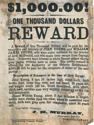 A vintage, water-stained poster using words to describe a reward for two criminals.