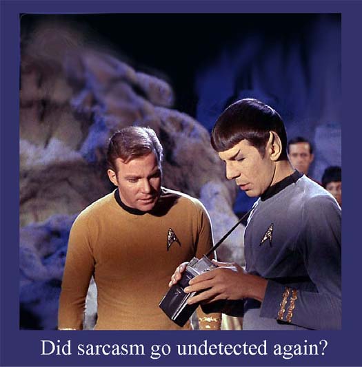 Captain Kirk and Spock examine a device in front of a purple rock background.