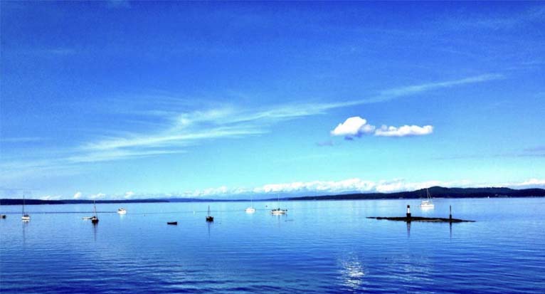 Landscape view of blue sea with Cypress Mountain in the background.