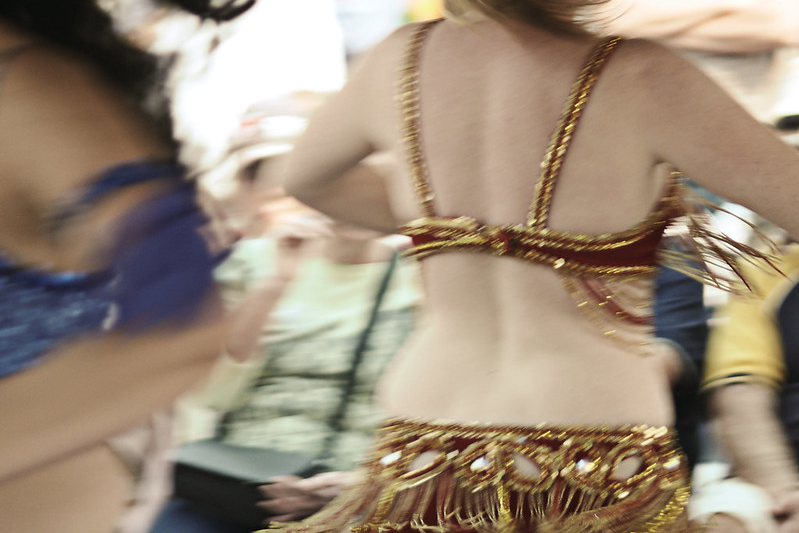 A slightly blurry image of a belly dancer shaking that fringe