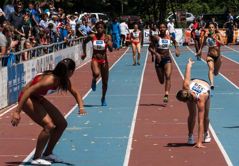 Women running a relay race.