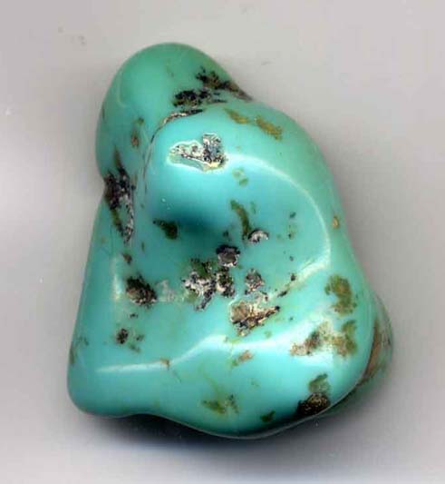 A lumpy polished turquoise stone in a roughly triangular shape.