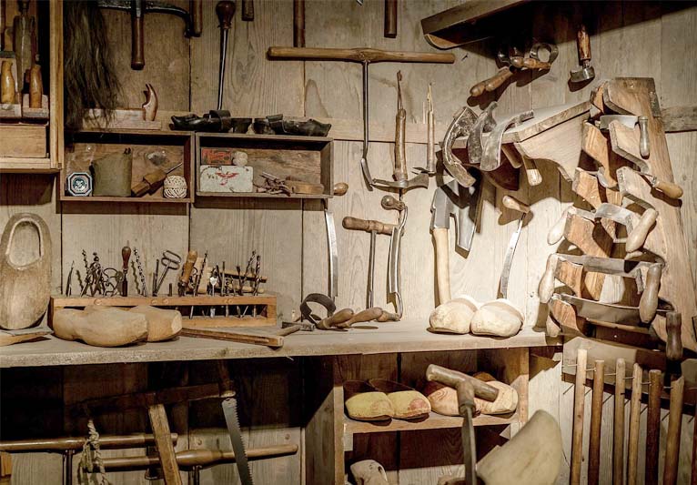 In tones of brown, a carpentry workshop of old vintage tools to make wooden shoes.