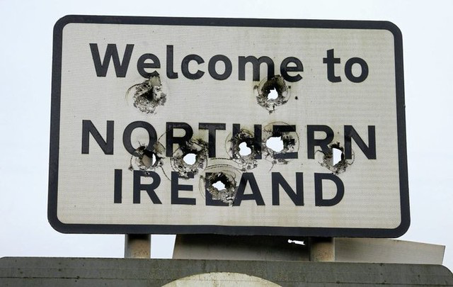 A Welcome To Northern Ireland sign riddled with bullet holes