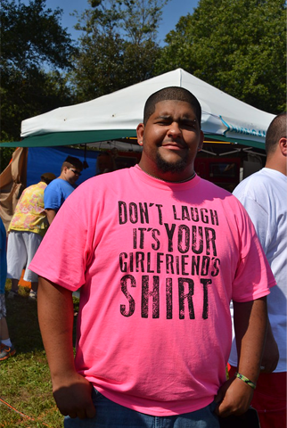 Bright pink T-shirt says Don't Laugh, It's Your Girlfriend's Shirt